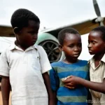 비아프라 전쟁과 아프리카 원조 문제 - **A scene of hope amidst hardship:** A group of resilient Biafran children, clothed in simple but cl...